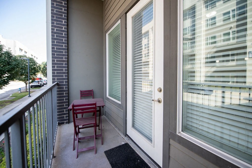 a patio with a table and chairs on a balcony