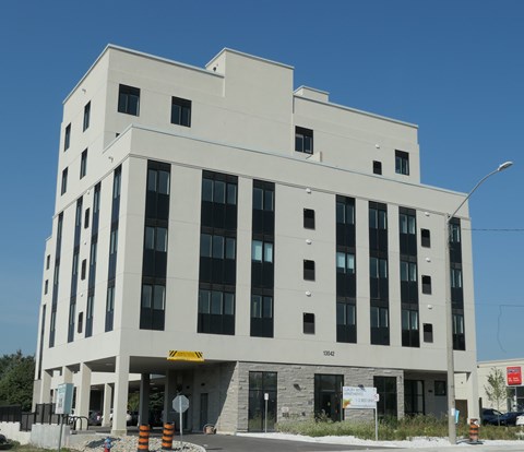 A large white building with a yellow caution sign on the front.