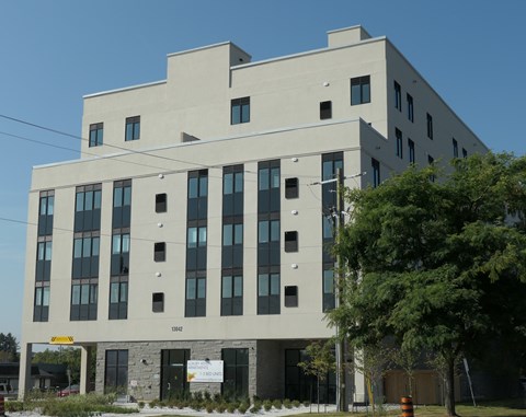A modern building with a flat roof and a sign that reads "1848" on the front.