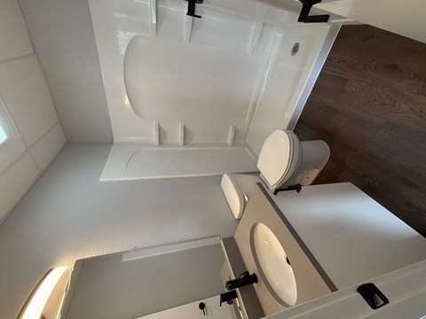 A white toilet with a white tank is in a small bathroom.