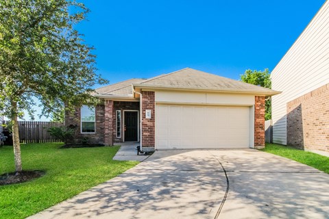 a house with a driveway and a garage door
