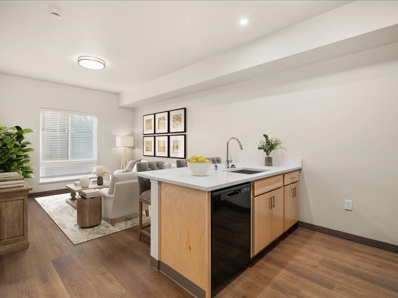 A modern kitchen with wooden cabinets and a large island.
