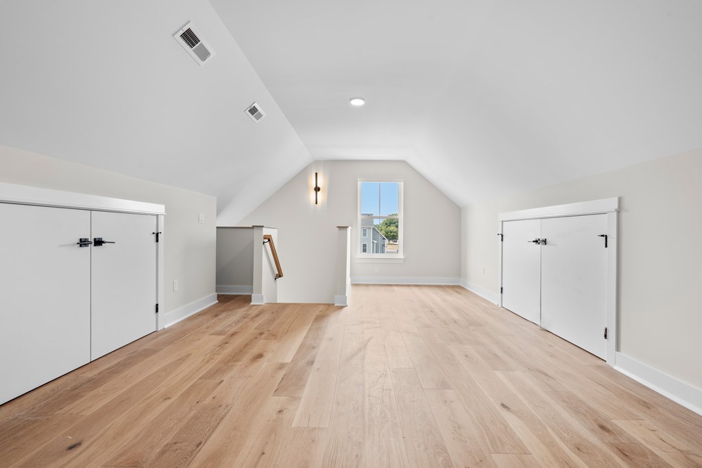 A room with white walls and wooden flooring.