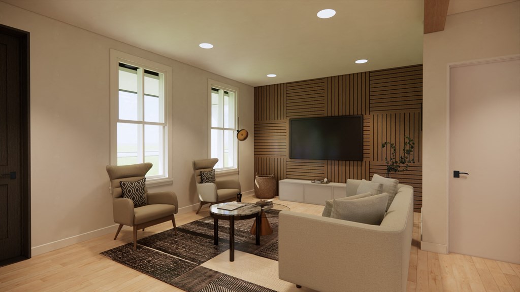 a living room with a couch and chairs and a television