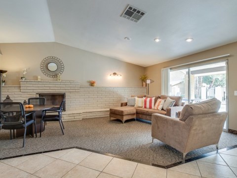 a living room with a couch and a table and a fireplace