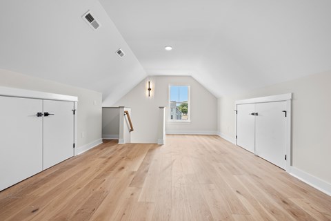 A room with white walls and wooden flooring.