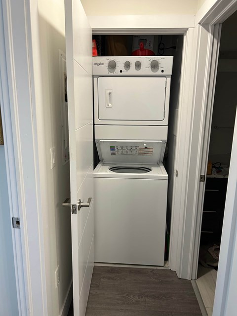 A white dishwasher and oven are in a small kitchen.
