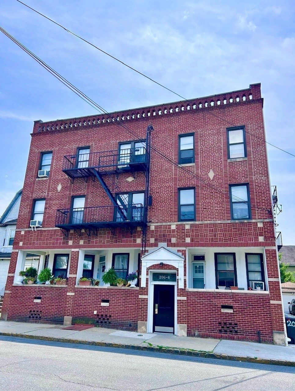 A red brick building with a black fire escape.