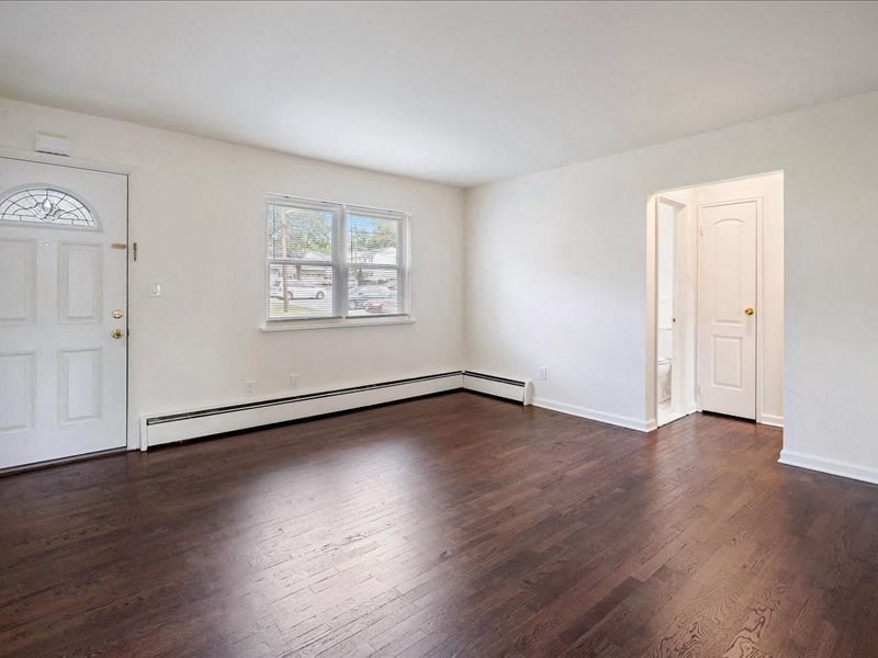 A room with wooden floors and white walls.