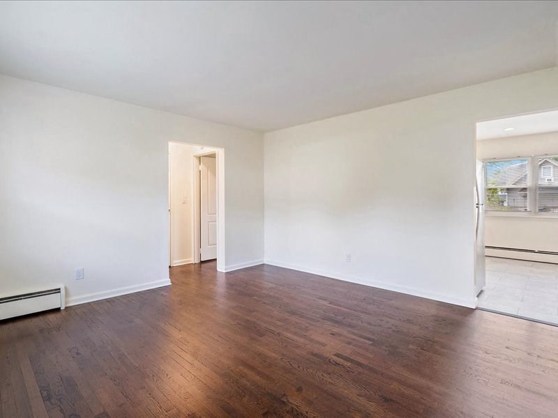 A room with wooden floors and white walls.