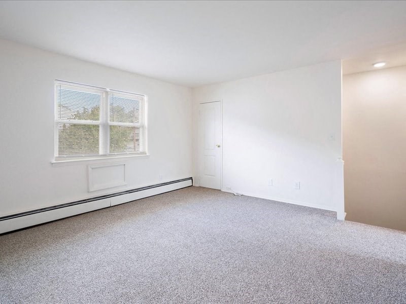 A room with a window and a door.