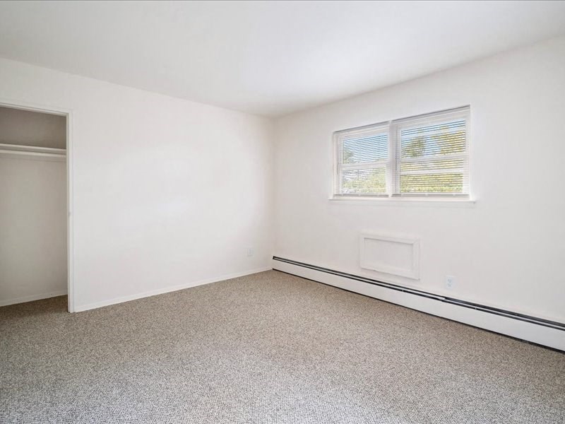 A room with a window and a door.