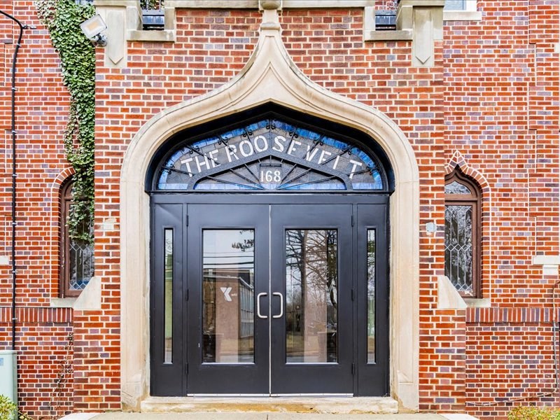 The Roosevelt building has a black door with a glass window.
