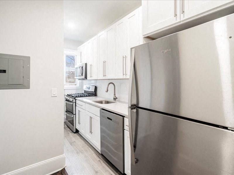 A modern kitchen with a stainless steel refrigerator.
