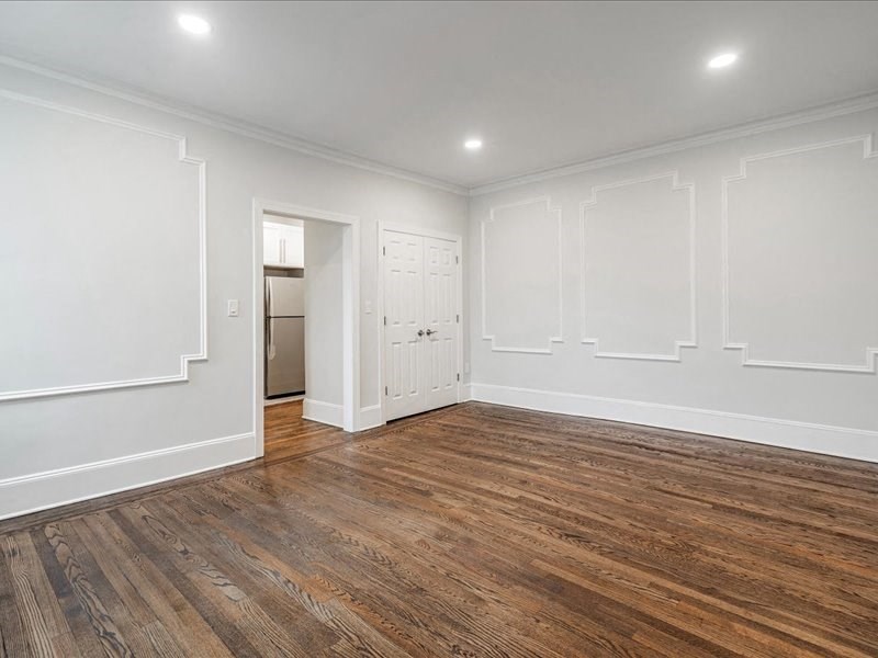 A room with wooden floors and white walls.