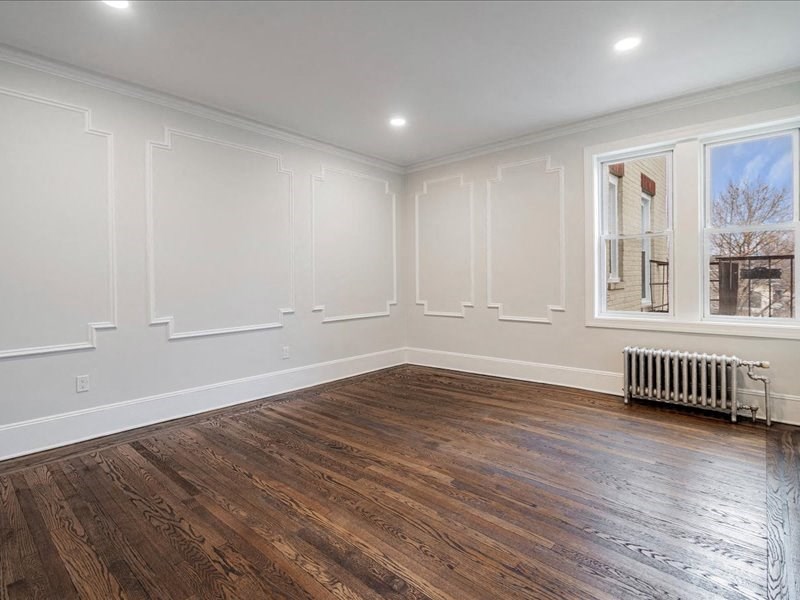 A room with wooden floors and white walls.
