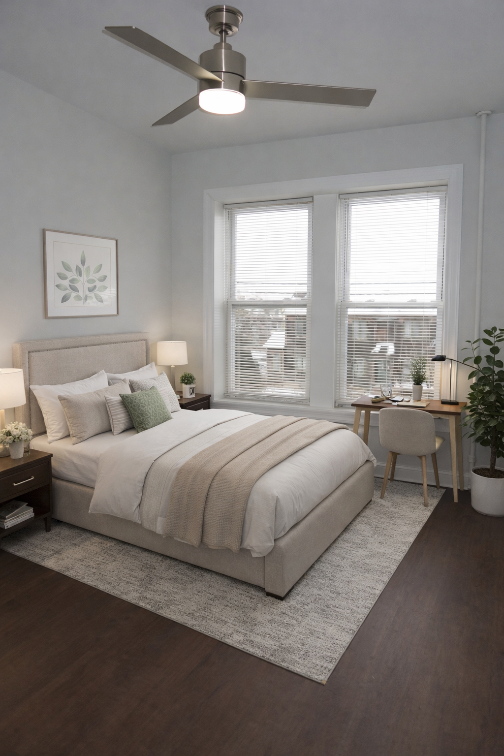 A bedroom with a large bed and a ceiling fan.