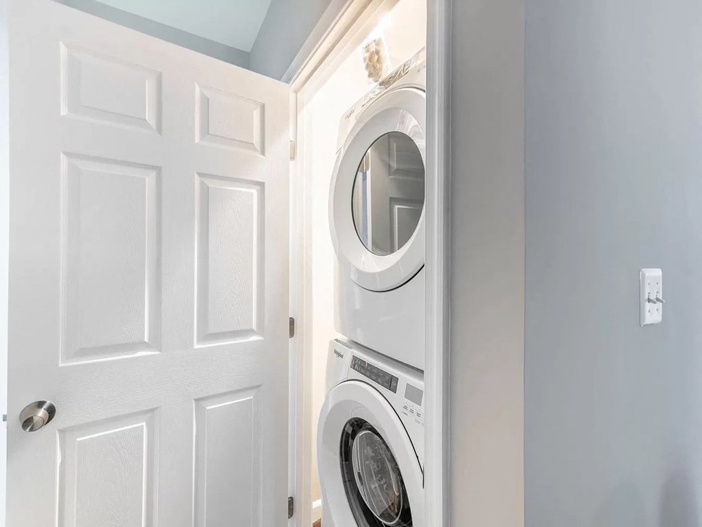 a white washer and dryer in a small laundry room