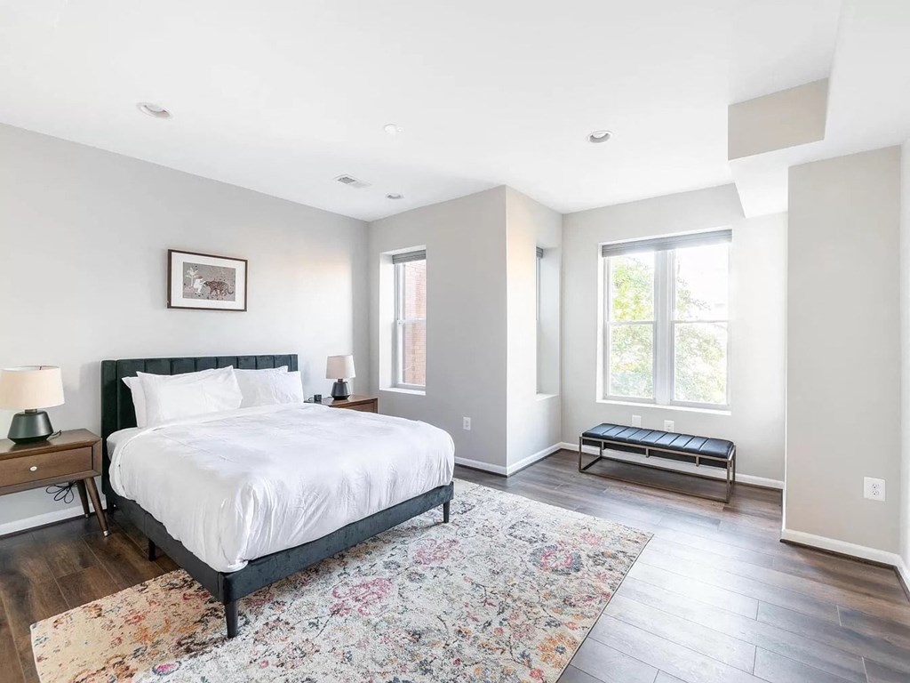 a bedroom with a bed and a rug