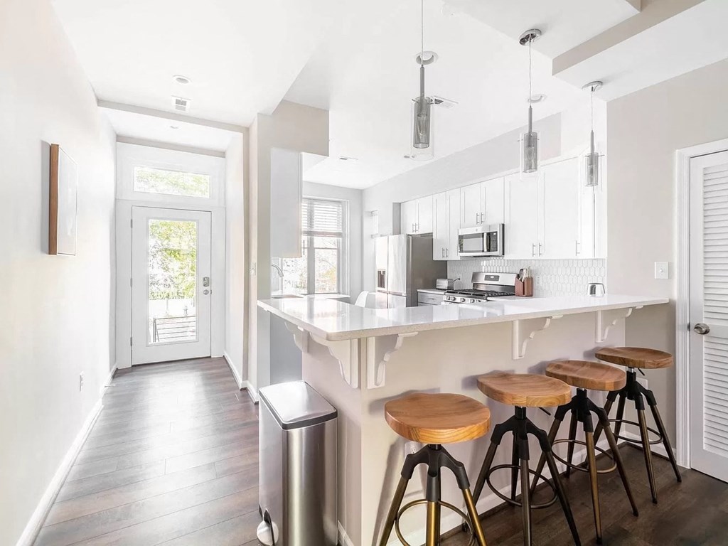 a kitchen with a counter and bar stools