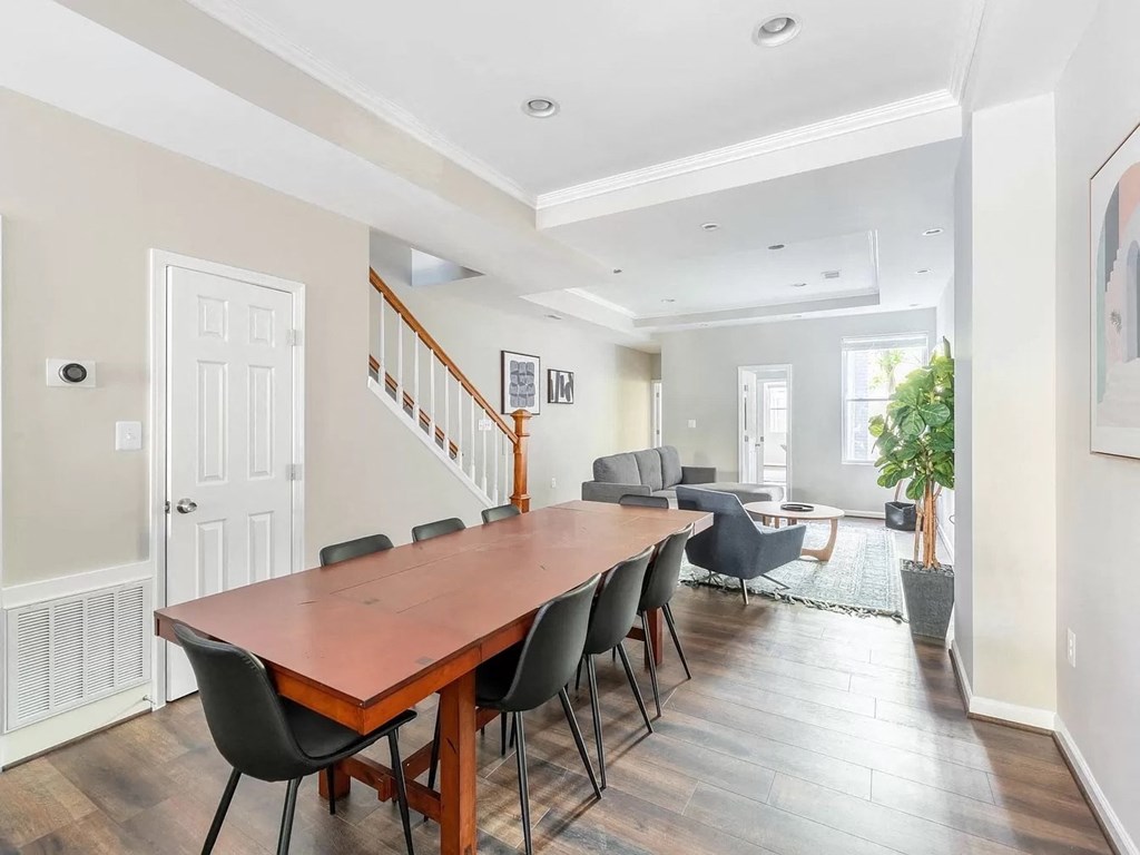 a dining room with a long wooden table and chairs