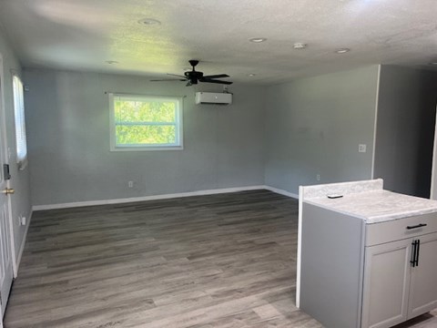 A room with a ceiling fan and a window.