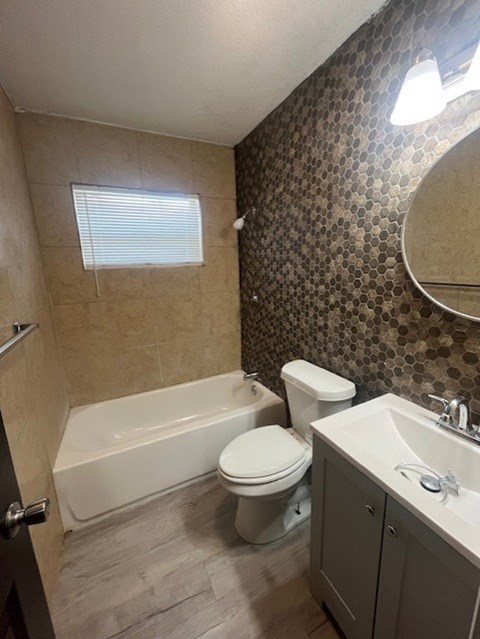 A bathroom with a white tub, toilet, and sink.
