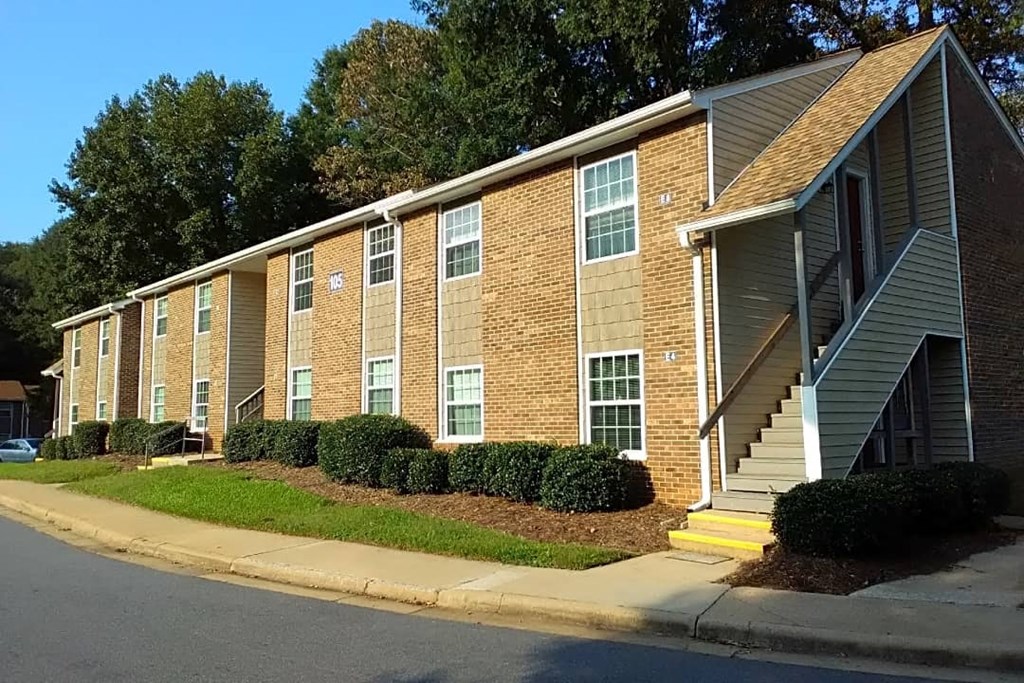 a brick apartment building with stairs