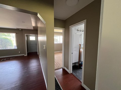 a view of a living room and a hallway with wood floors