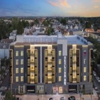 an aerial view of a building with a city in the background