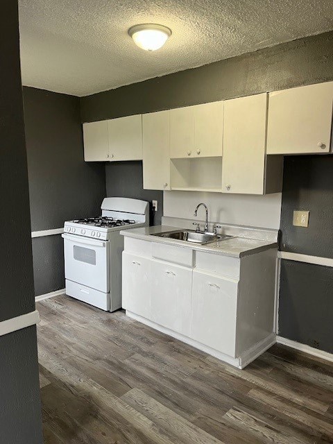 A kitchen with white appliances and cabinets.