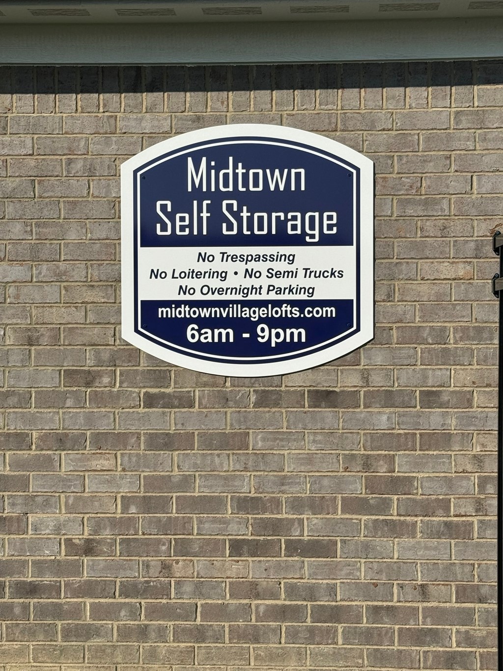 a sign on the side of a brick building