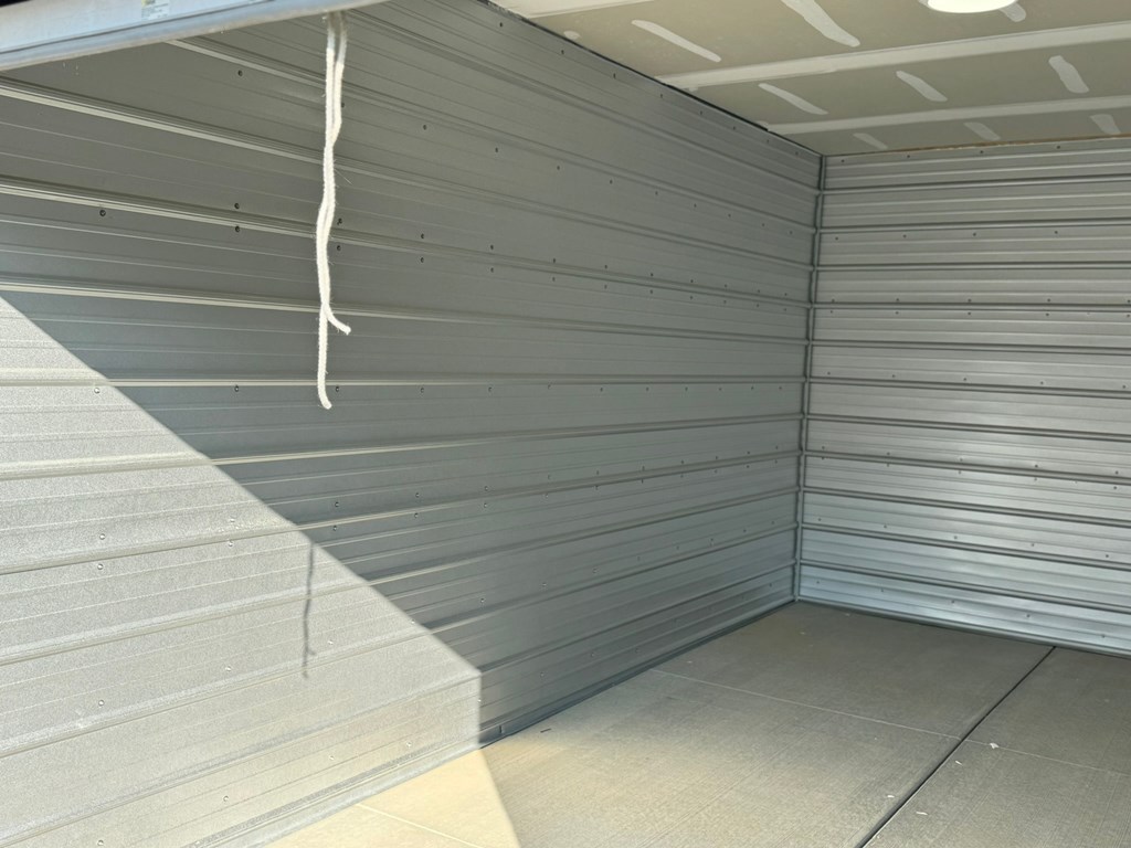 the inside of a storage room with grey walls and a white ceiling