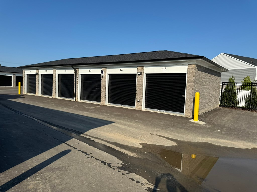 a row of garage doors in front of a building