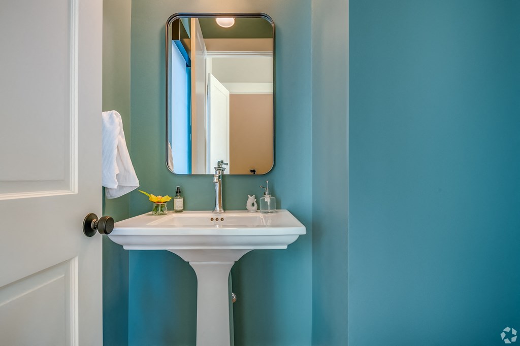 A white sink with a mirror above it.