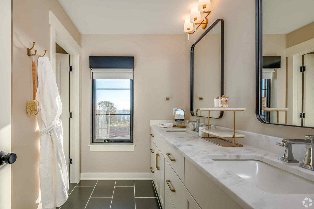 A bathroom with a white towel hanging on a hook.