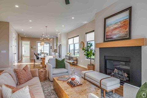A living room with a fireplace and a painting on the wall.