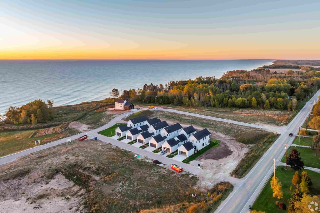 A house is being built on a plot of land by the sea.