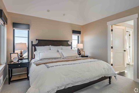 A bedroom with a large bed and a window.
