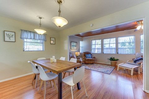 a dining room and living room with a table and chairs