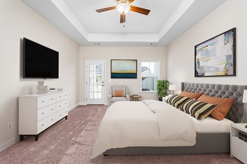 a bedroom with a bed and a ceiling fan