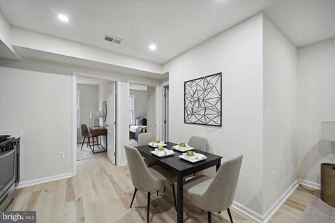 a dining room with a table and chairs
