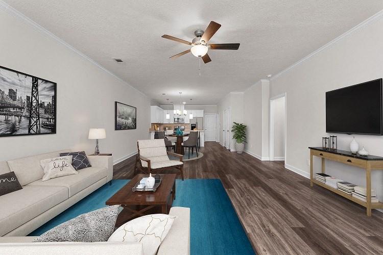 a living room with a ceiling fan and a blue rug