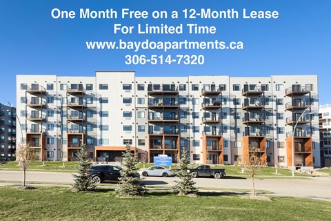 A large apartment complex with a sign offering a free month on a 12-month lease.