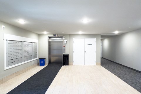 A clean, empty office space with a trash bin and recycling bin.