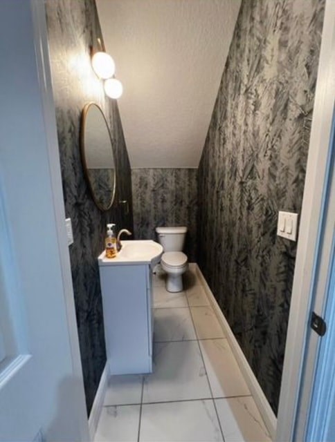 A bathroom with a toilet and sink.