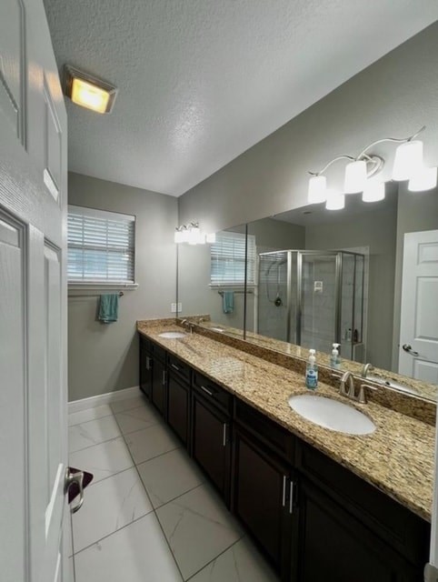 A bathroom with a sink, mirror, and lighting fixtures.