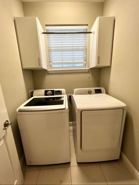 A small laundry room with a washer and dryer.