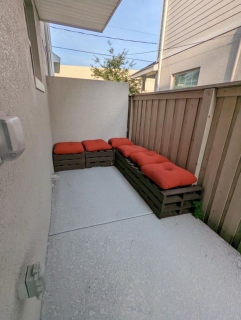 A small patio with a bench made of wooden pallets.
