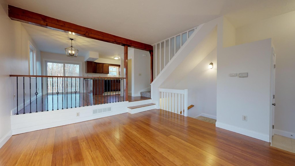 A room with wooden floors and a staircase.